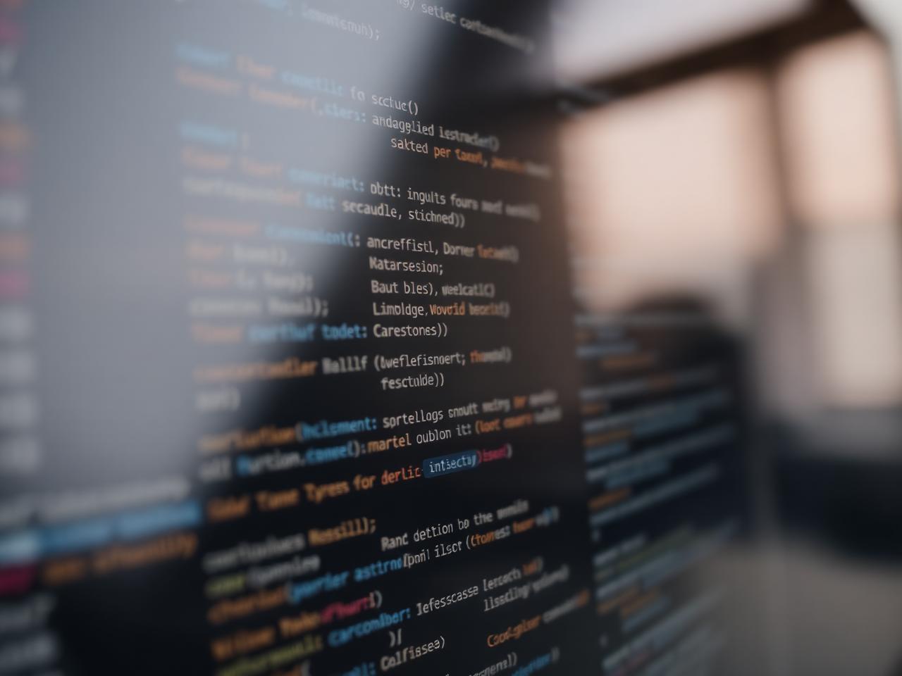 Source code displayed on a dark monitor in a software engineering workspace